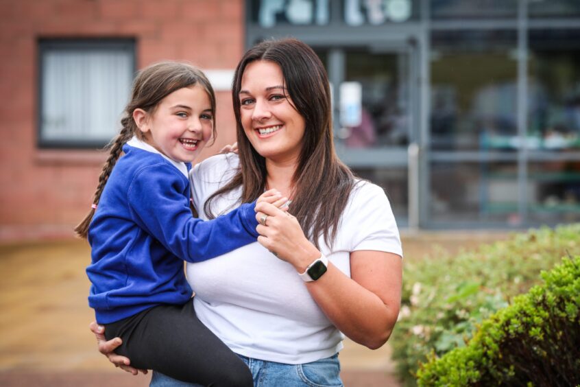 Whitehills Primary Gaelic pupil Jorja-Grace with her mum outside the school.