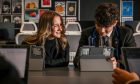 Woodmill High School pupils Hannah McRitchie and George Foxlow try out the iPads which will be distributed. Image Mhairi Edwards/DC Thomson.