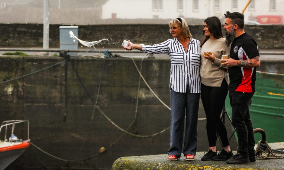 Fiona Boyter (Nicola's mum), alongside Nicola and Sian, pay tribute to Martin at Anstruther harbour.