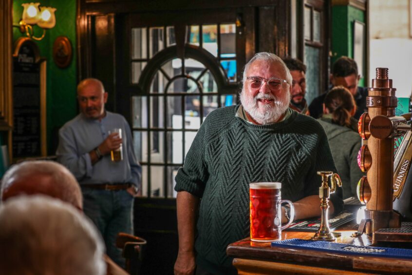 Owner of the Pillars John Justice with a pint of beer. 