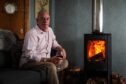 Stewart Ross at home in Dundee with his wood burning stove. Image: Mhairi Edwards/DC Thomson.