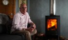 Stewart Ross at home in Dundee with his wood burning stove. Image: Mhairi Edwards/DC Thomson.