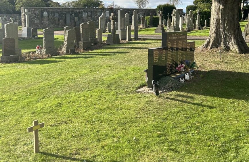 A memorial to Fife stillborn babies in St Andrews Western Cemetery, with Pearl's cross in the foreground. 