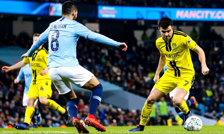 Scott Fraser takes on Ilkay Gundogan of Manchester City in the League Cup semi-final.