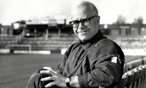 Elton John sitting in the stand at Watford FC's Vicarage Road