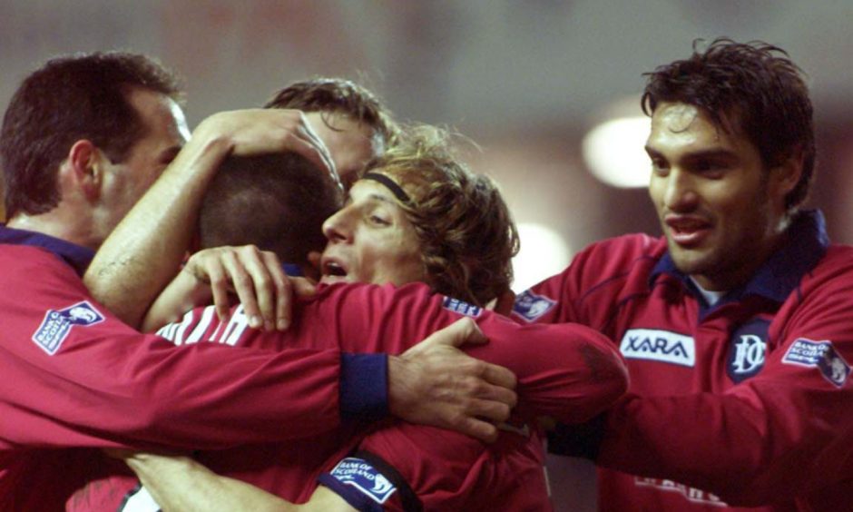 Dundee team-mates mob Claudio Caniggia after he found the net against Rangers at Ibrox in 2001. Image: SNS