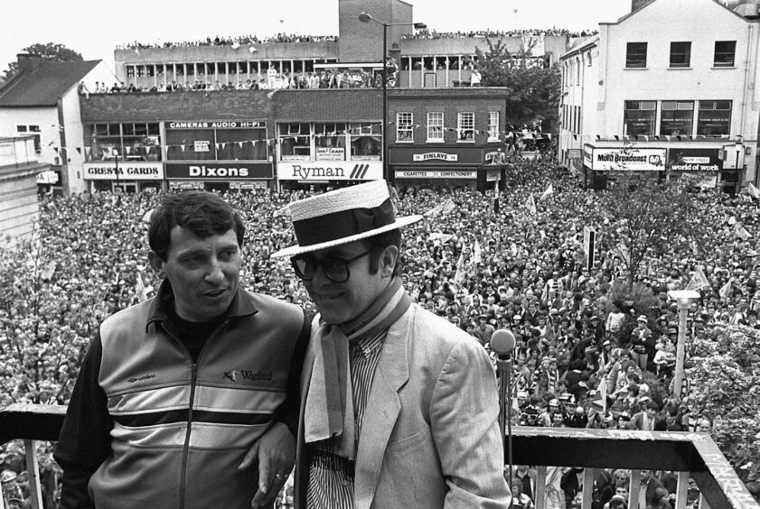 Graham Taylor and Elton John overlooking celebrating Watford fans in May 1984.