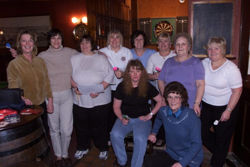 Players from the Whip Inn getting ready to toe the oche. 