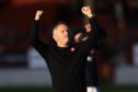 Tony Docherty salutes the Dundee fans after victory at Motherwell. Image: David Young/Shutterstock