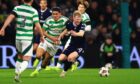 Lyall Cameron in possession for Dundee at Celtic Park. Image: David Young/Shutterstock