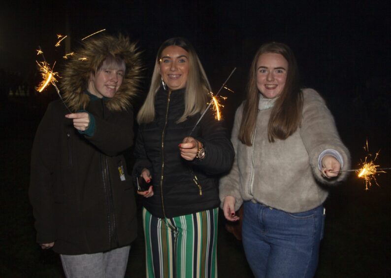 three young women with sparklers