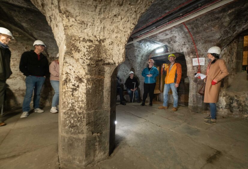 Gayle, in the fawn coat, takes a tour of Dundee's vaults.