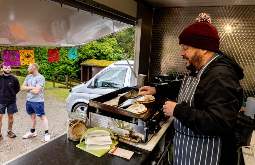 David Lowe works at the grill in Zacatecas Mexican food Truck at Crombie Park.