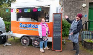 David and Hazel Lowe outside their Mexican food truck at Crombie Country Park, pointing to their menu.