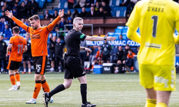 Craig Napier points to the spot deep into stoppage time