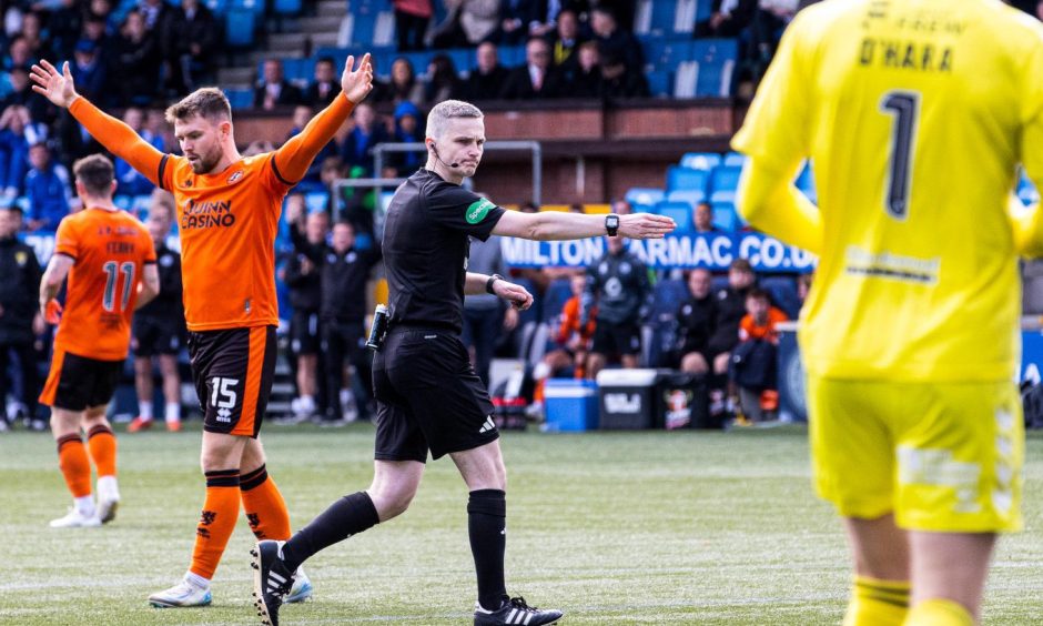 Craig Napier points to the spot deep into stoppage time