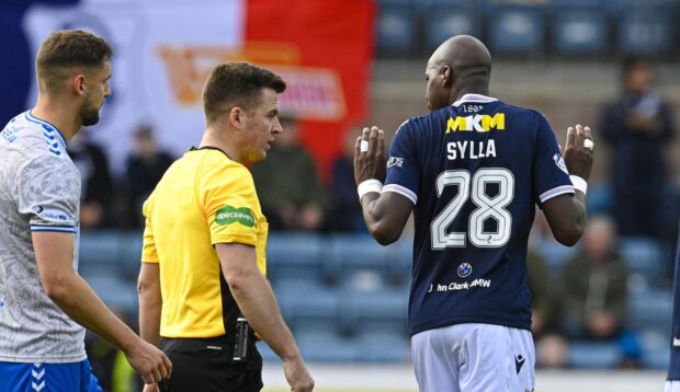 Mo Sylla pleads his innocence with referee Grant Irvine after his red card. Image: Rob Casey/SNS