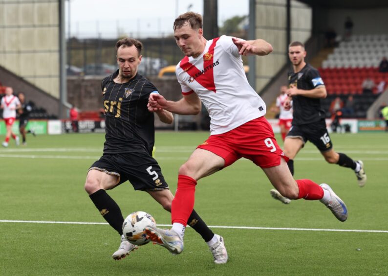 Dunfermline defender Chris Hamilton challenges Airdrie striker Aaron Reid.