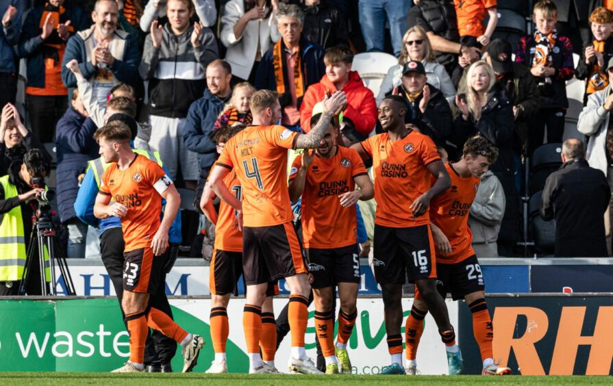 Emmanuel Adegboyega takes the acclaim of his Dundee United teammates