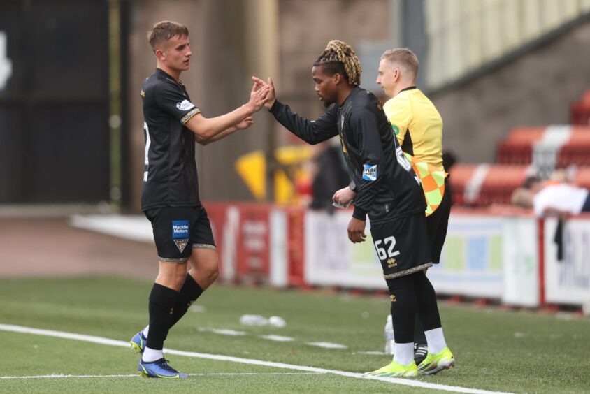 Dapo Mebude shakes hands with Matty Todd as he comes on as a substitute.