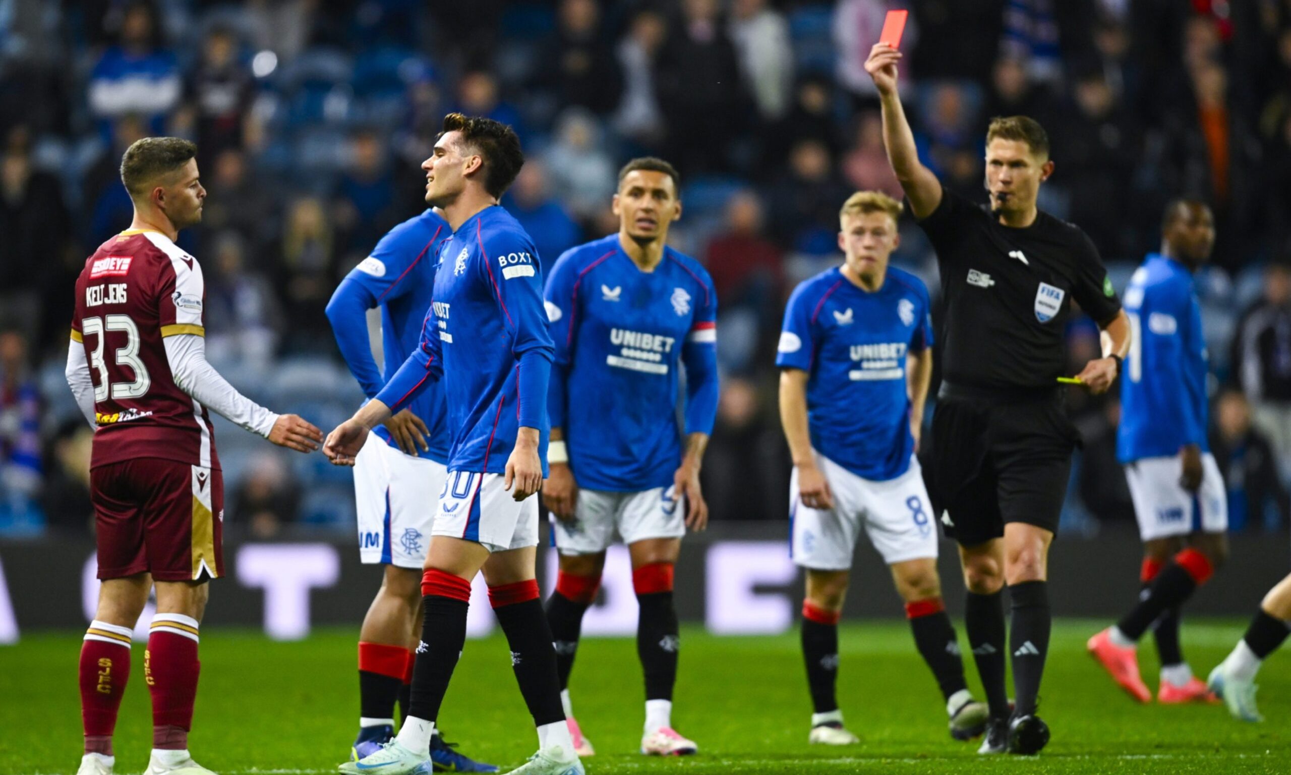 Rangers' Ianis Hagi is shown a red card for a foul on St Johnstone's Benji Kimpioka.