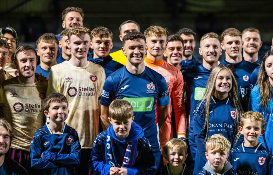 Raith Rovers midfielder Ross Matthews surrounded by players and mascots before his testimonial match against Hearts.