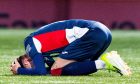 Raith winger Josh Mullin kneels on the ground with his head in his hands.