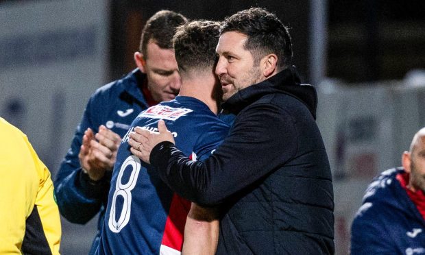 Liam Fox embraces Ross Matthews as the Raith Rovers stalwart is substituted during his testimonial.