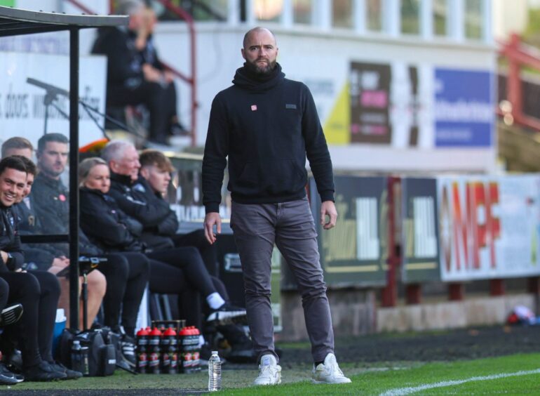 Dunfermline boss James McPake stands in his technical area at East End Park.