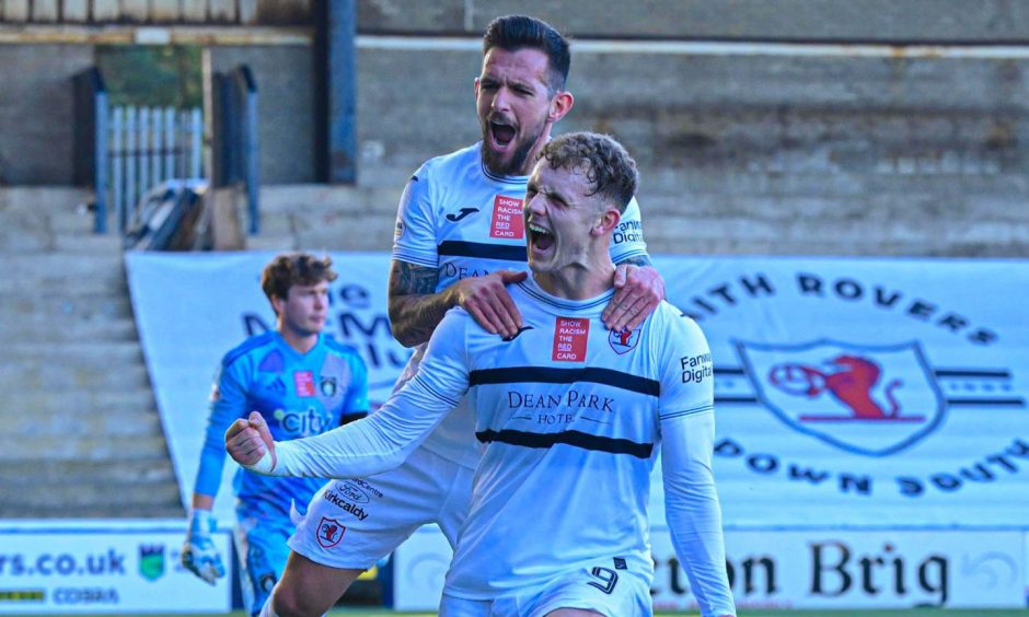 Dylan Easton jumps on Jack Hamilton's shoulders as he celebrates his team-mate's successful penalty for Raith Rovers.