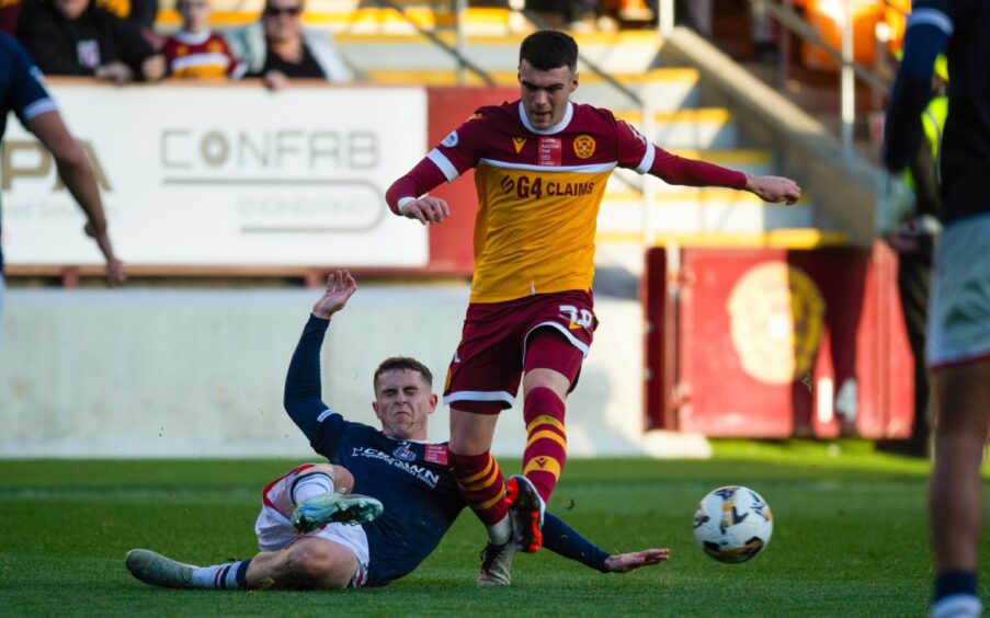 Dundee midfielder Fin Robertson tackles Motherwell star Lennon Miller. 