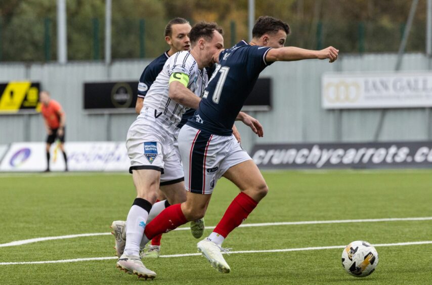 Pars skipper Chris Hamilton and Falkirk midfielder Dylan Tait clash in the box.