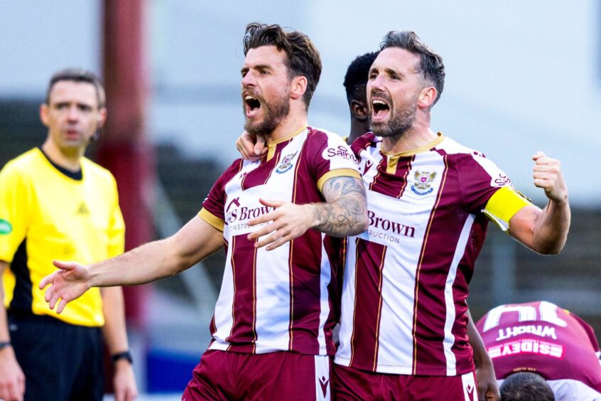 Graham Carey celebrates with Nicky Clark after scoring to make it 1-1.