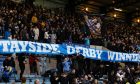 St Johnstone fans unfurl a banner at full-time to mark their victory at Dens Park.