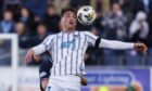 Dunfermline Athletic striker Lewis McCann attempts to control a high ball on his chest,