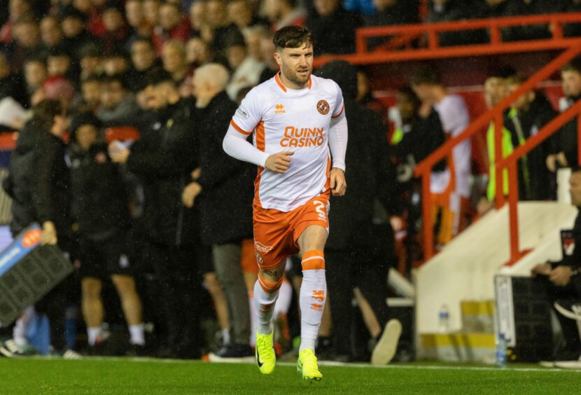 Ryan Strain enters the action on his long awaited Premiership debut for Dundee United