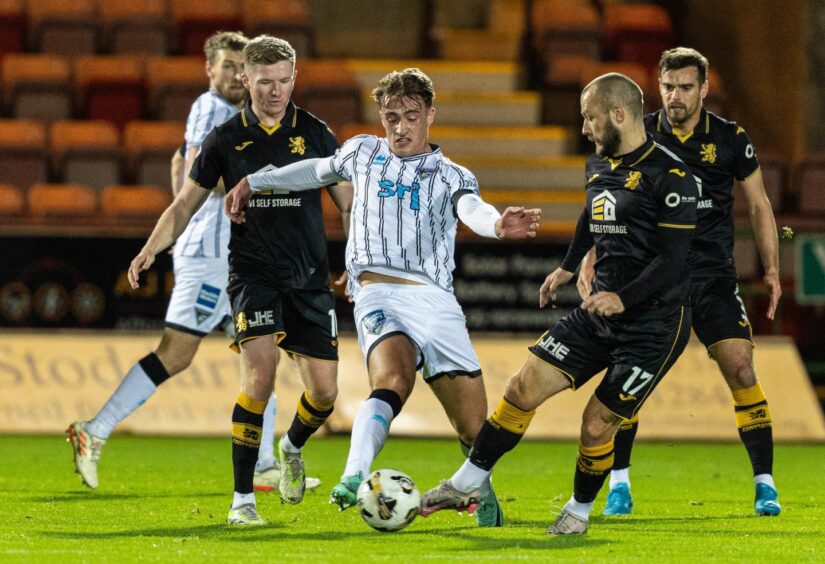 Dunfermline forward Lewis McCann challenges for the ball against Livingston.