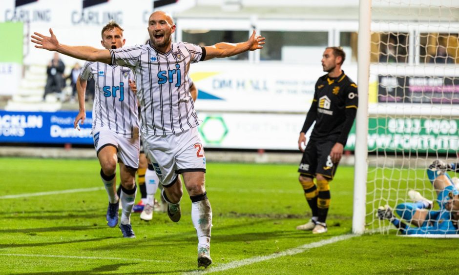 Chris Kane runs away with his arms in the air as he celebrates Dunfermline's third goal in the 3-0 win over Livingston.