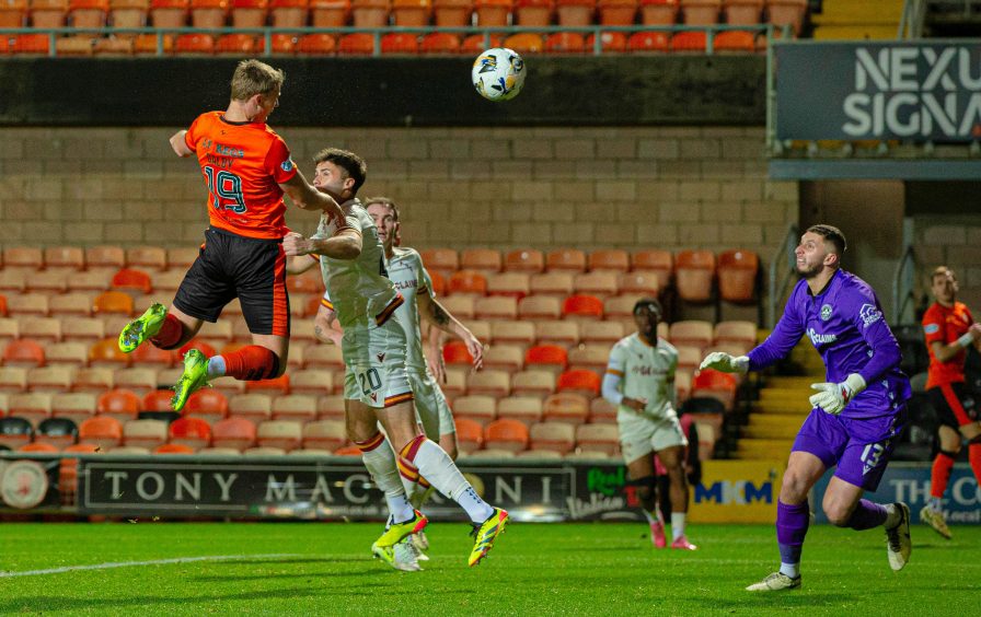 Sam Dalby leaps high to head in Dundee United's equaliser against Motherwell.