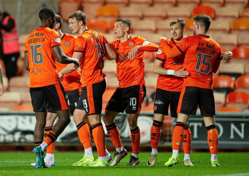 Dalby is congratulated by United team-mates, including Manny Adegboyega 