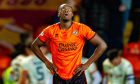 Dundee United defender Emmanuel Adegboyega looks dejected after his mistake helped Motherwell seal a 2-1 victory at Tannadice.