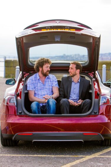 Chris and Jack enjoy a chat in the Tesla in 2014.