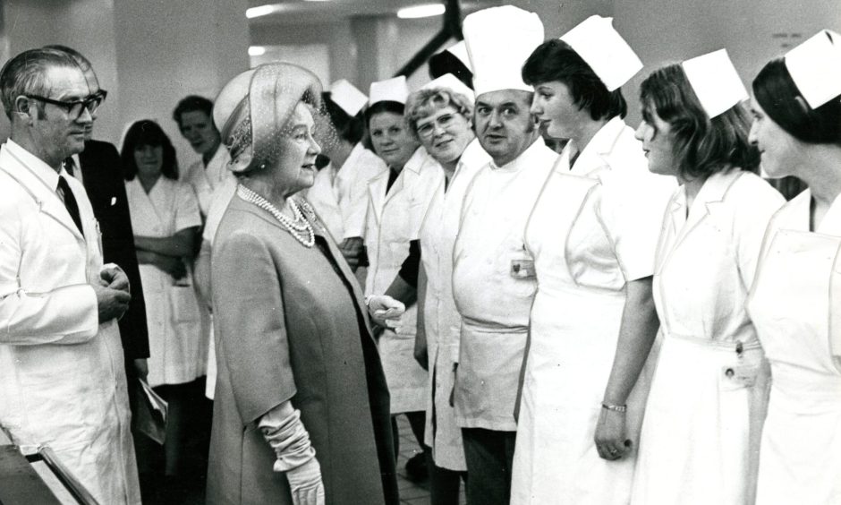 The Queen Mother with kitchen staff during the official opening. Image: DC Thomson.