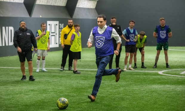 Anas Sarwar takes a penalty shot at the Street Soccer Scotland change centre in Lochee. Image: Alan Richardson/DC Thomson.