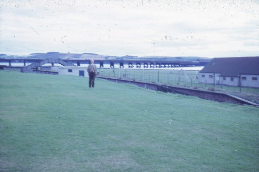 Professor Robert Percival Cook stands in a field beside the station's remains in 1964. 