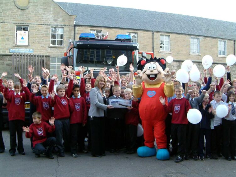 pupils in front of a fire engine for the launch of the poster competition in 2003. 