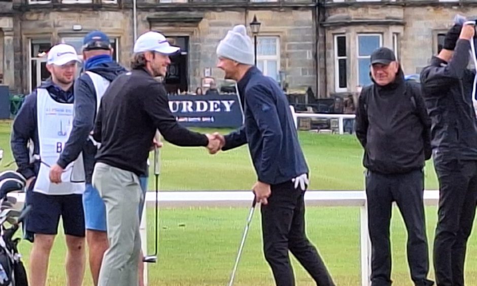 Football star Gareth Bale shakes hands with Keane frontman Tom Chaplin before they head off round the Old Course together