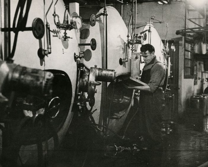 John Gunning taking a reading at the conditioning tanks, which are taller than he is, at Ballingall's in 1961. 