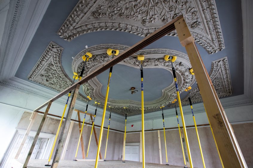 A bedroom ceiling being held up with scaffolding. 