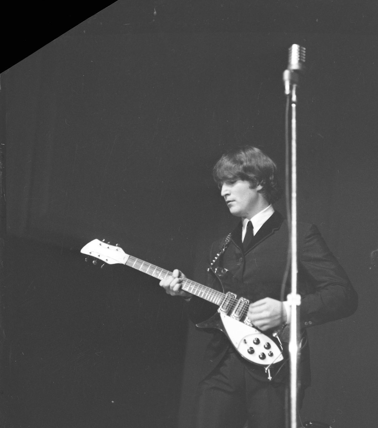 John Lennon playing the guitar at the Caird Hall in 1964. 